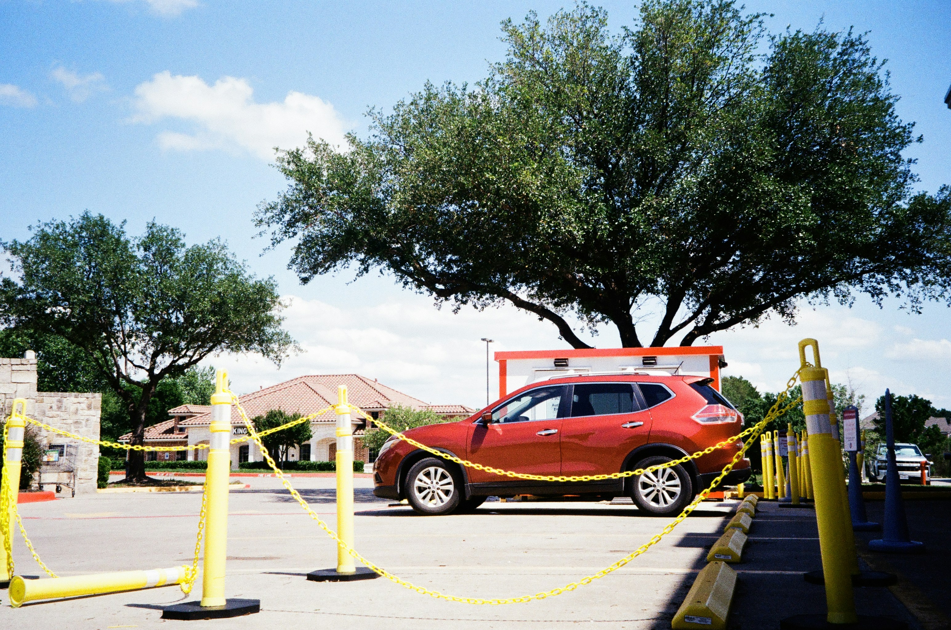 Family comparing prices of several electric vehicles at a dealership