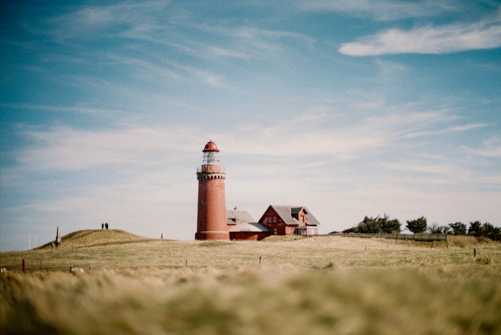 white and red lighthouse under blue sky during daytime