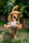 golden retriever puppy biting orange and white plush toy on green grass field during daytime