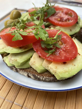 Close-up of a vibrant tropical brunch plate with fresh fruits and avocado toast.