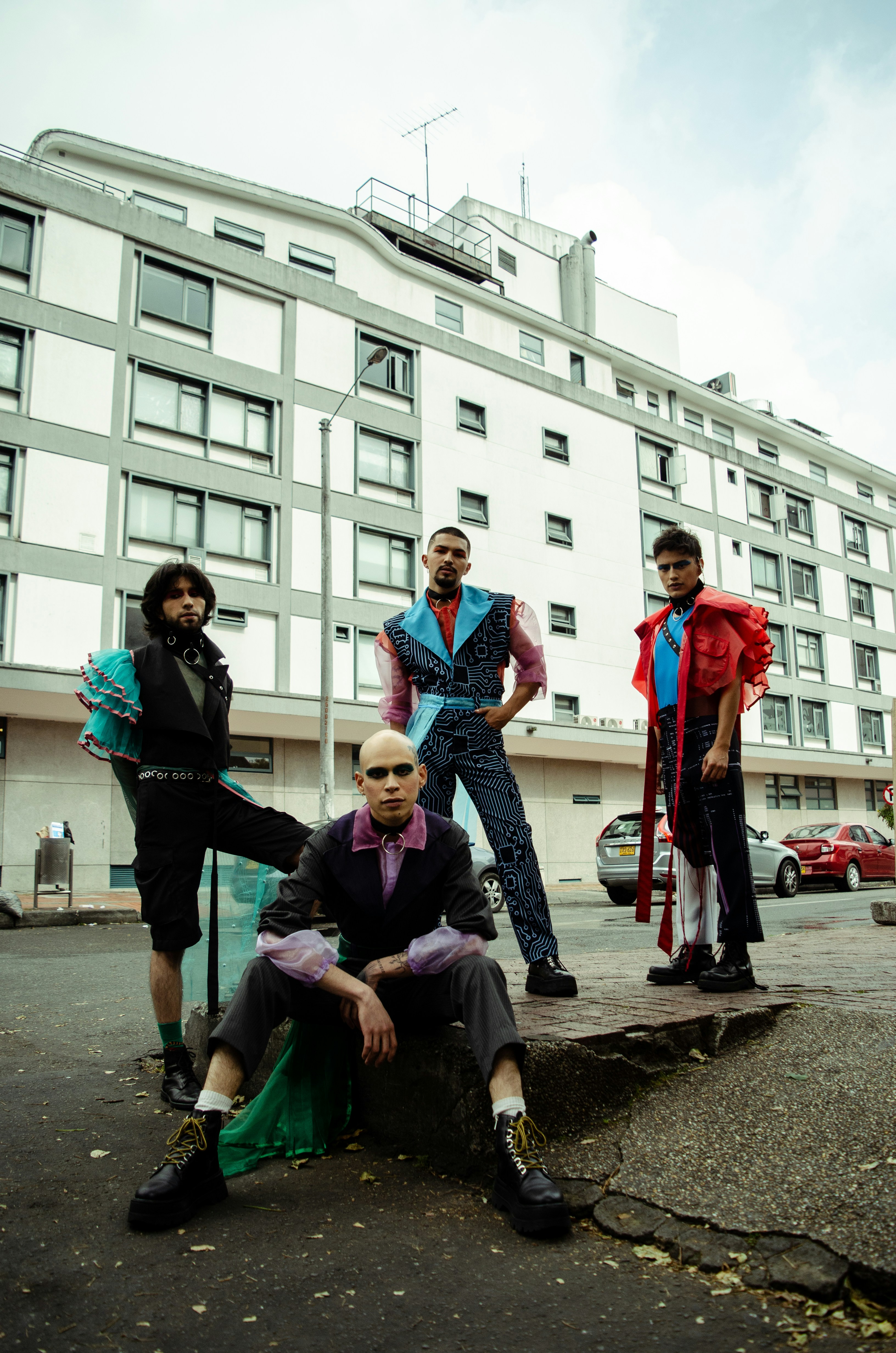 4 women standing near white concrete building during daytime