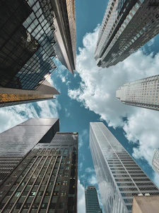 low angle photography of high rise buildings under blue sky during daytime