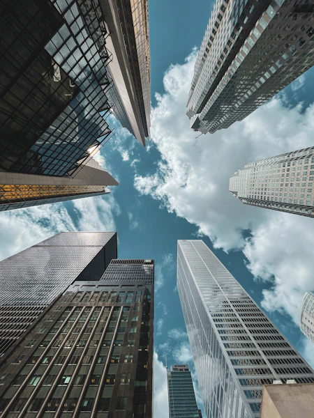 low angle photography of high rise buildings under blue sky during daytime