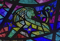 Detailed adult coloring page featuring a majestic lion surrounded by intricate floral patterns.