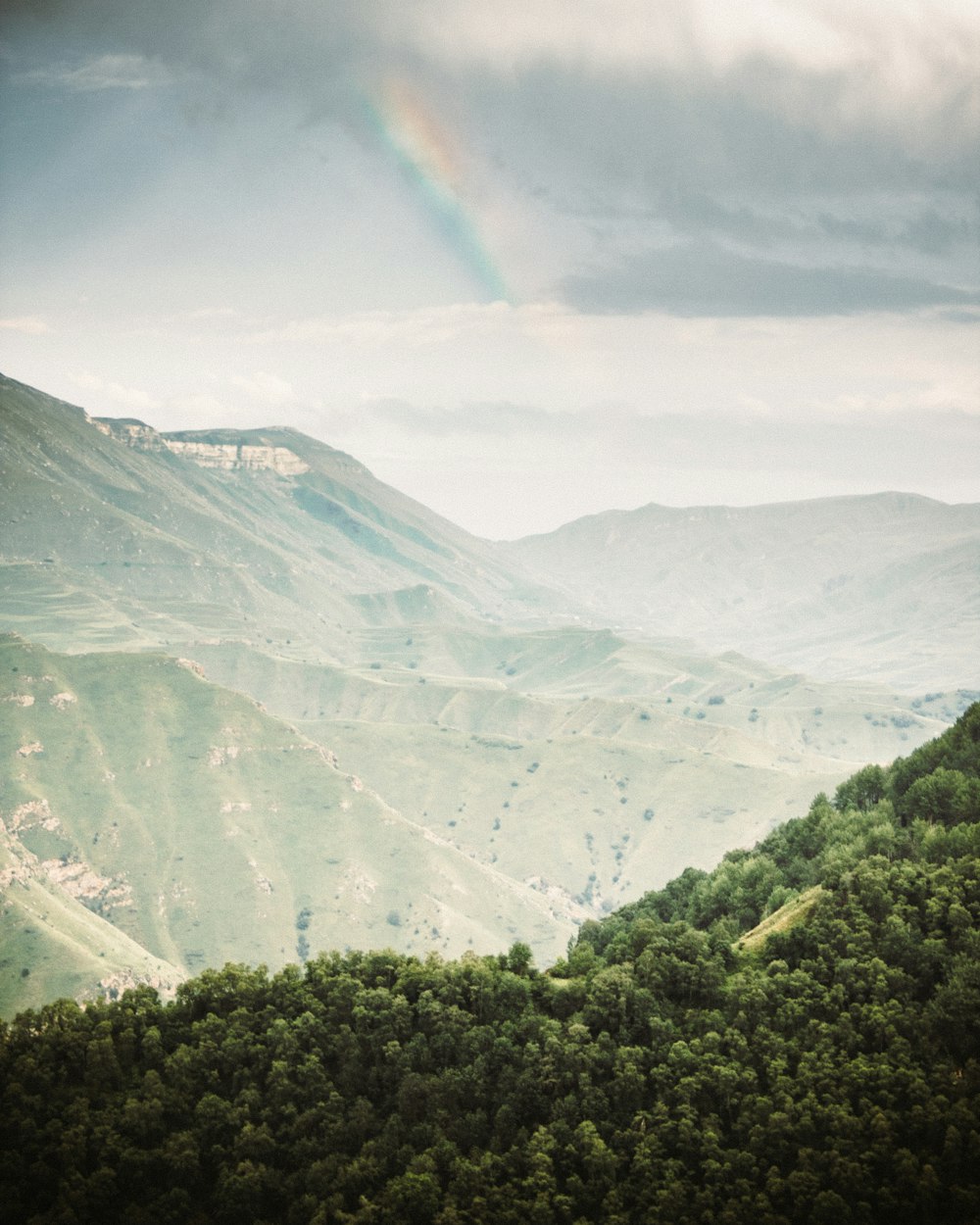 green mountains under white clouds during daytime