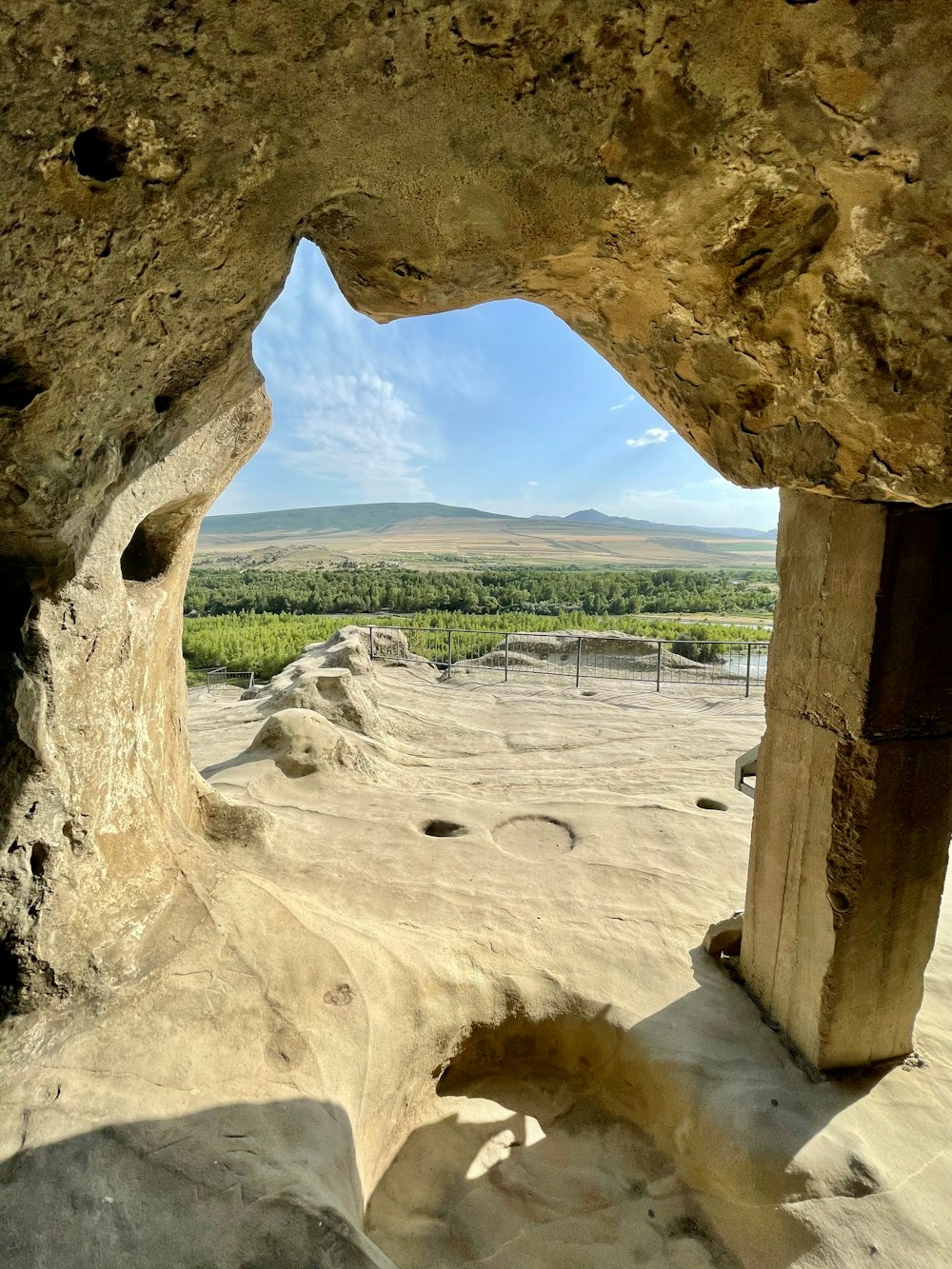 brown concrete arch near body of water during daytime