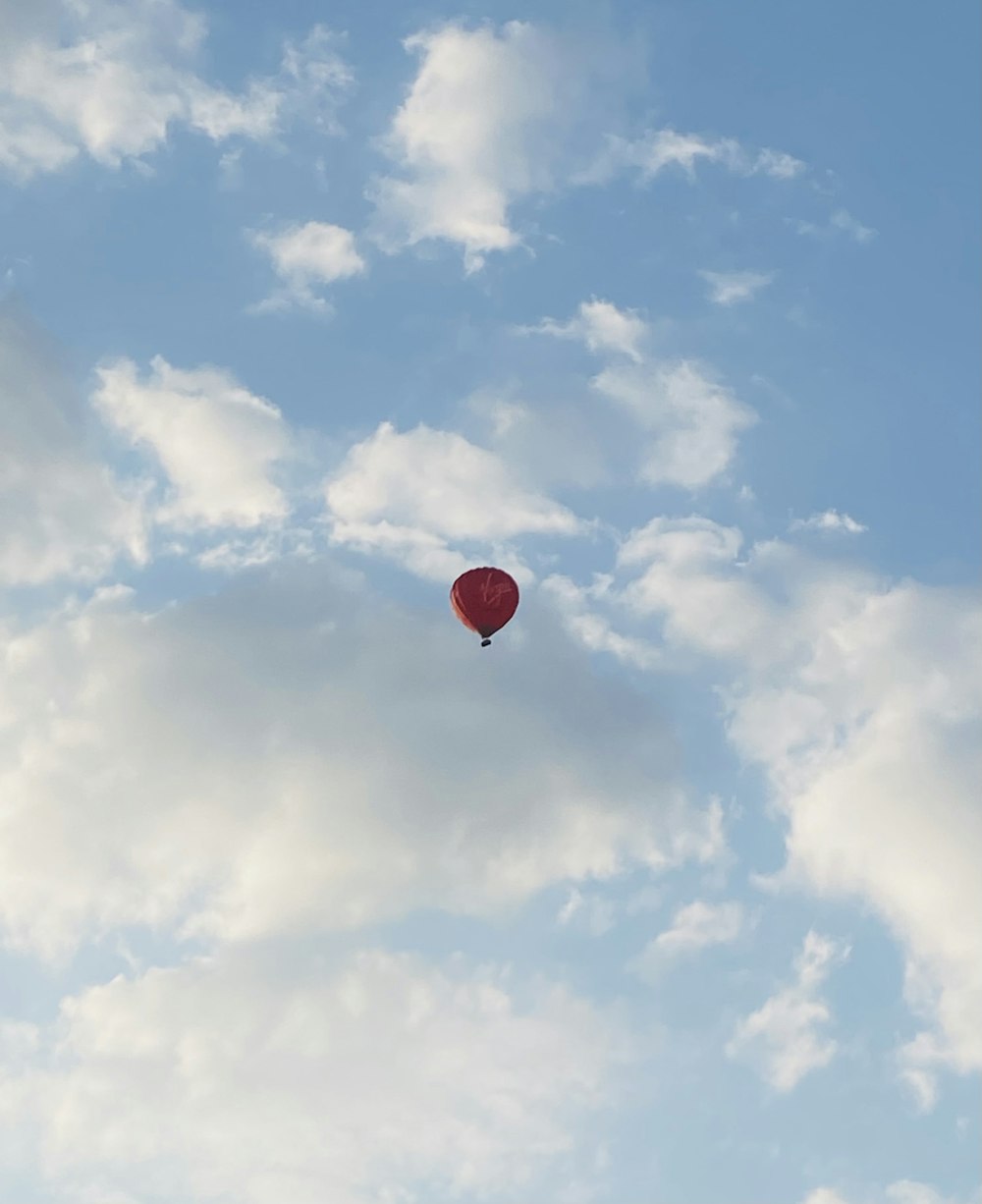 red hot air balloon in blue sky