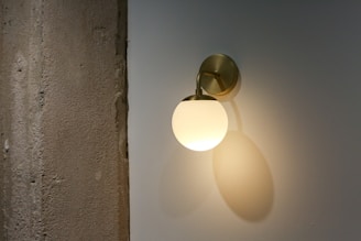 white light bulb turned on on white ceiling