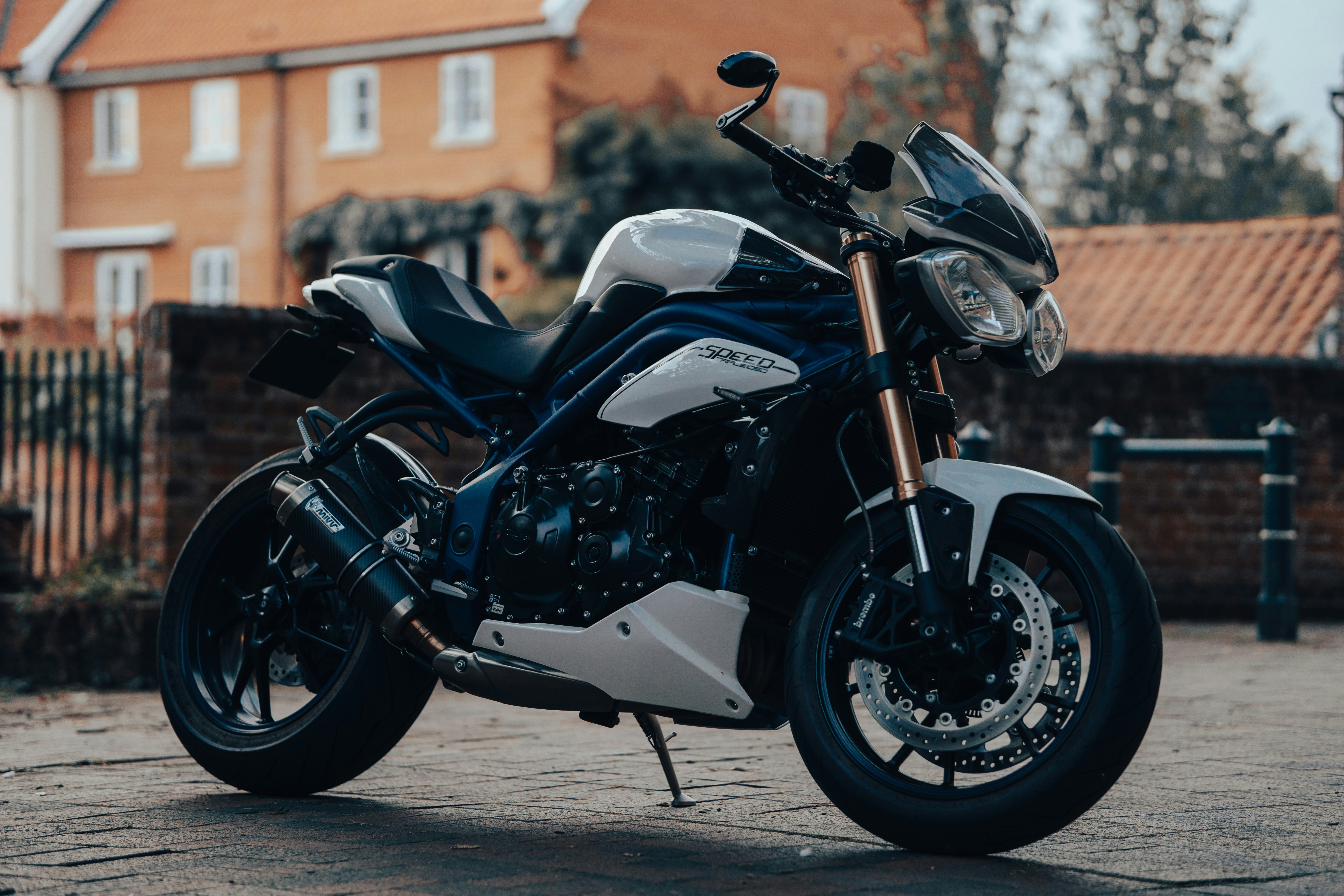 black and white sports bike parked on the street during daytime