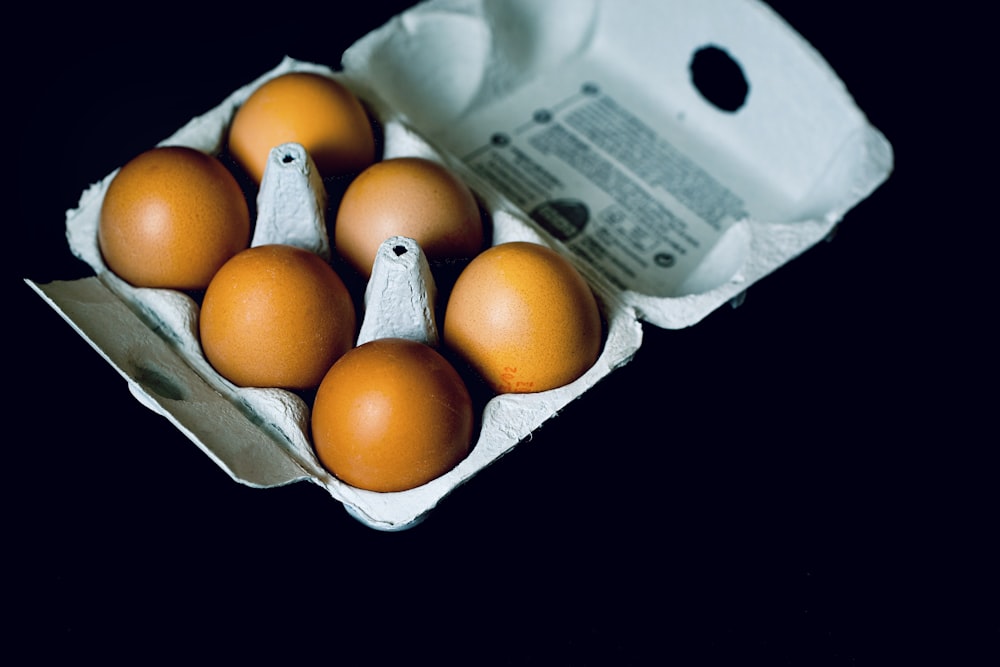 orange fruits in white plastic container