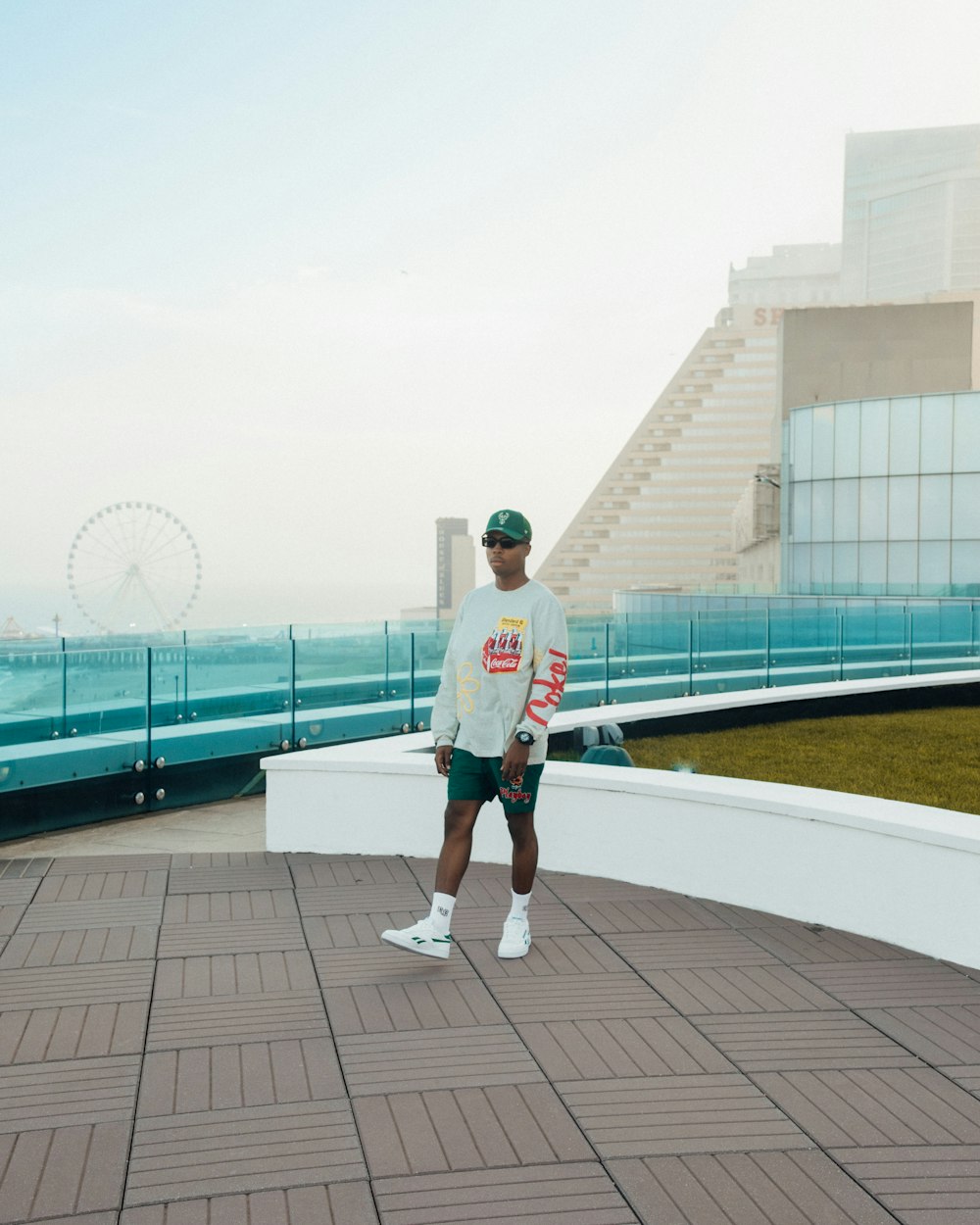 a man standing on top of a roof next to the ocean