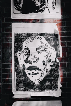 Close-up of a high-contrast graphic poster featuring bold black and white lines.