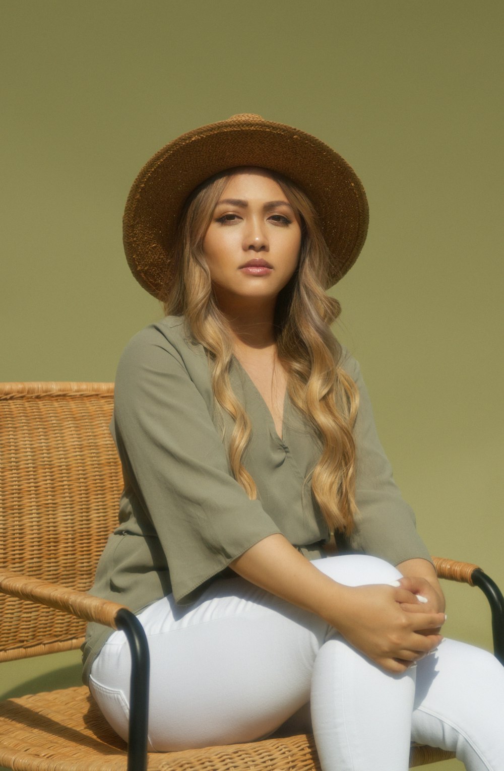 woman in brown hat and gray blazer