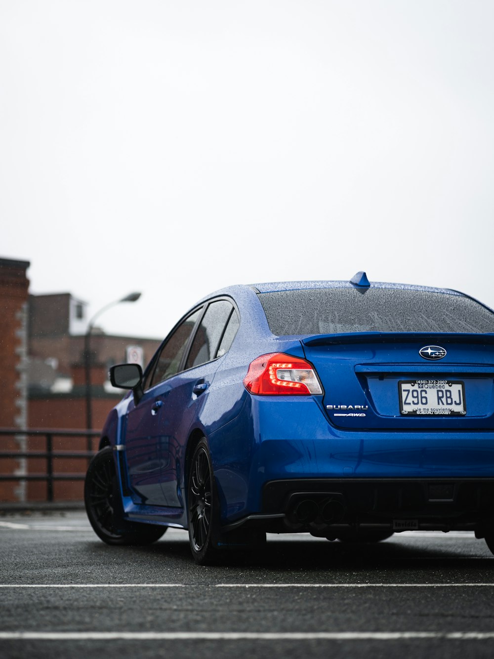 blue bmw m 3 coupe parked on sidewalk during daytime