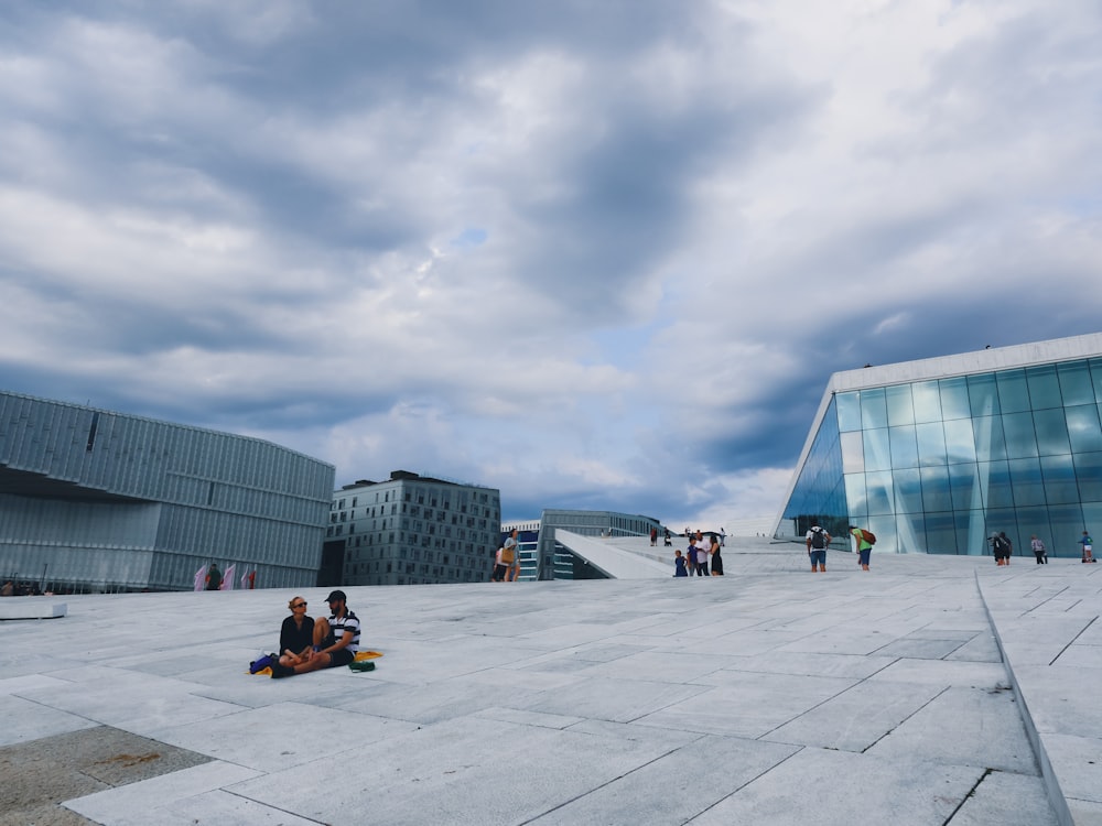 people sitting on white floor under gray sky during daytime