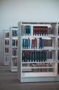 books on white wooden shelf