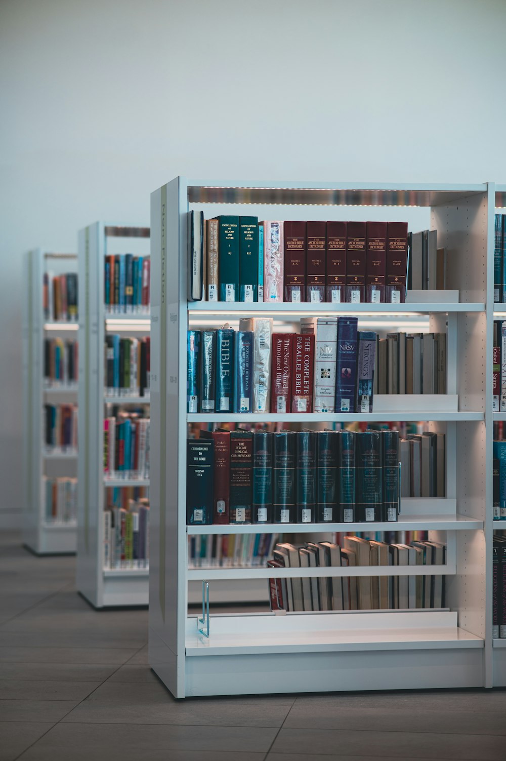 books on white wooden shelf