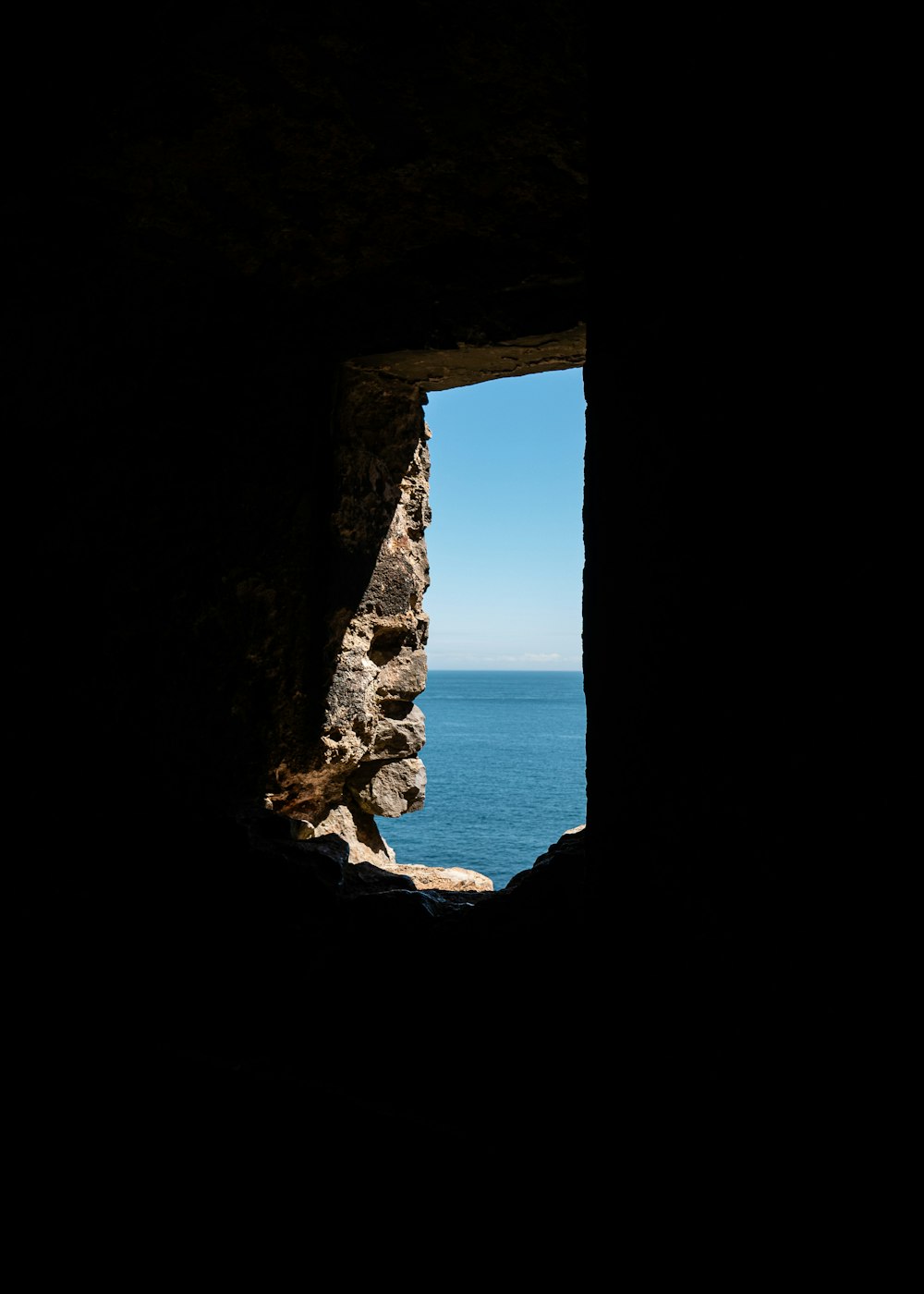 brown rock formation near body of water during daytime