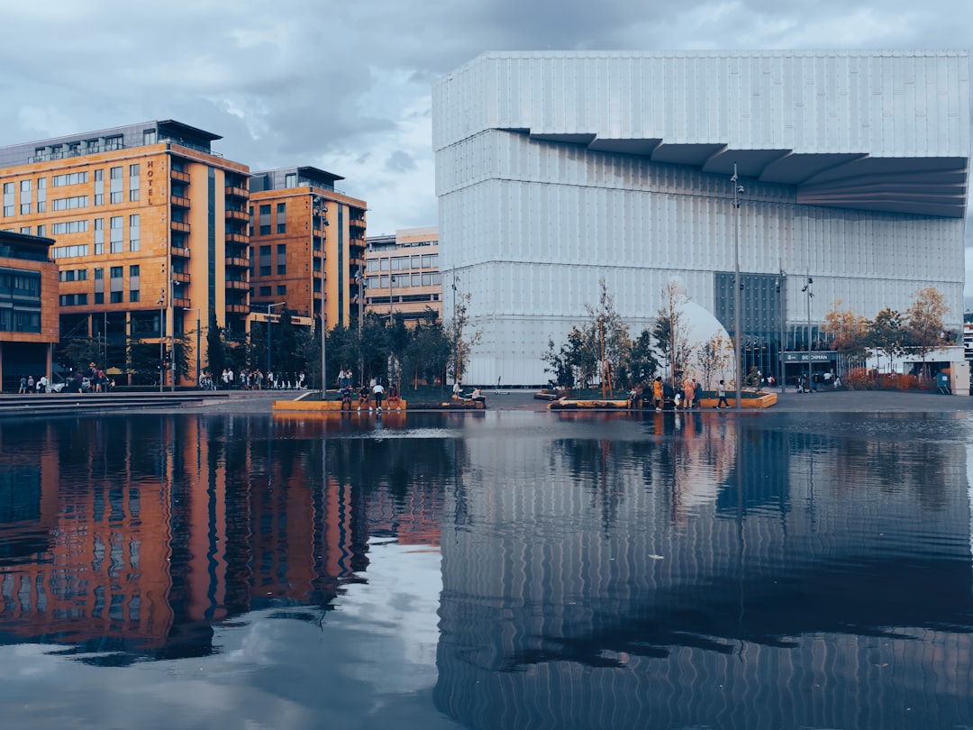 white and brown concrete building near body of water during daytime