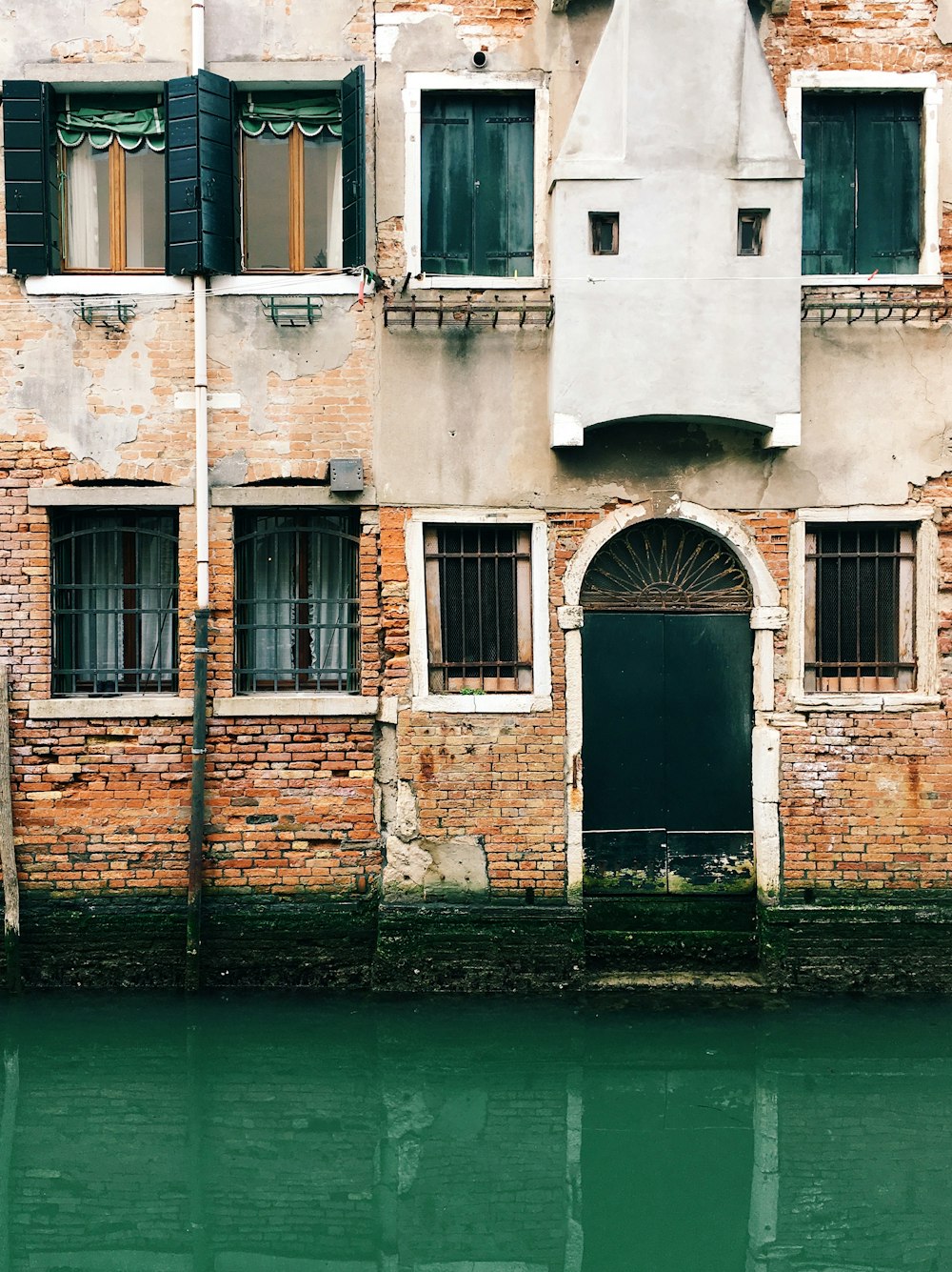 brown brick building beside river during daytime