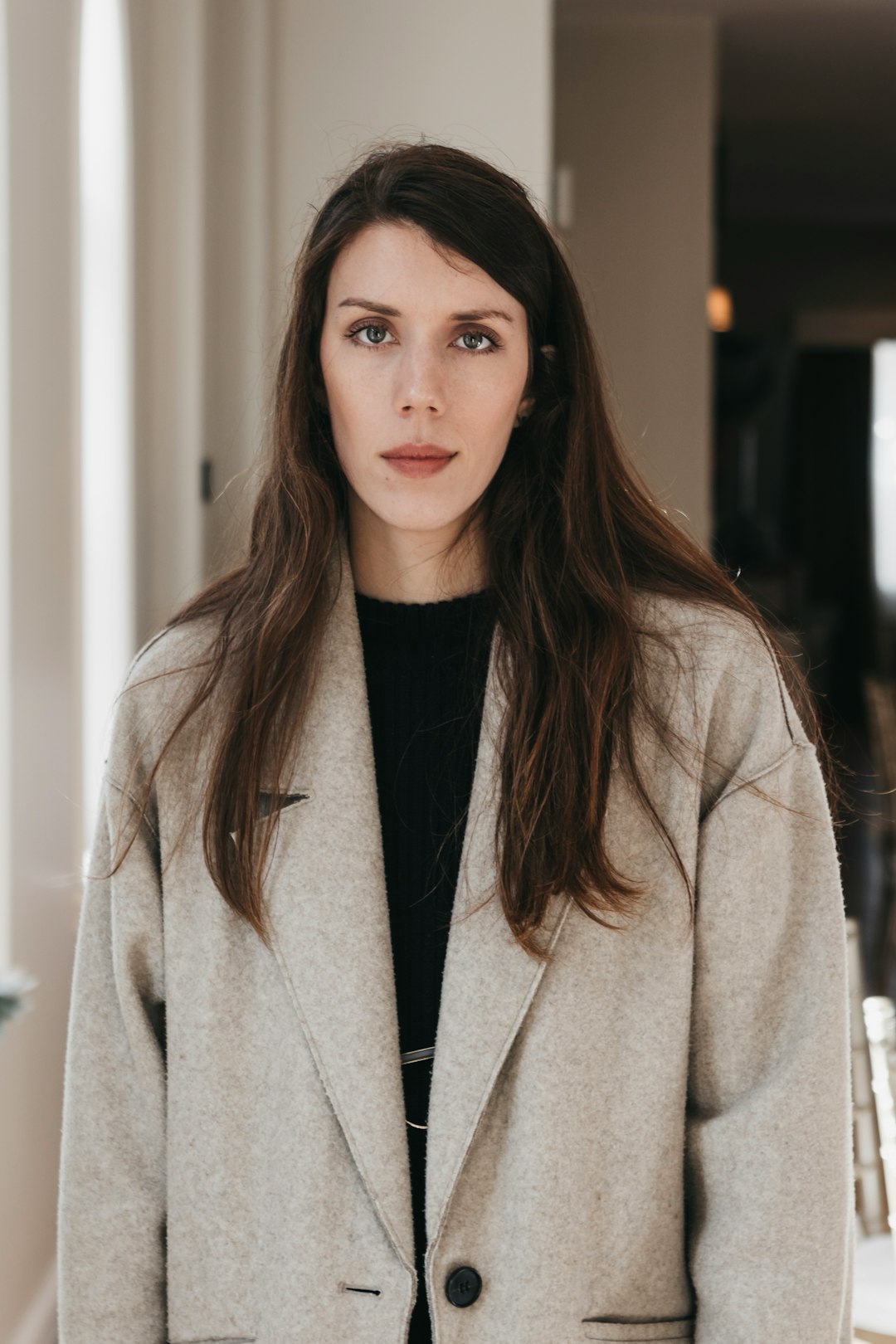 woman in beige coat standing