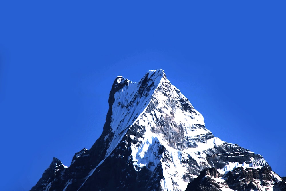 snow covered mountain under blue sky during daytime