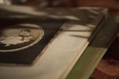 A close-up of hands holding a faded family photo album, symbolizing cherished memories.