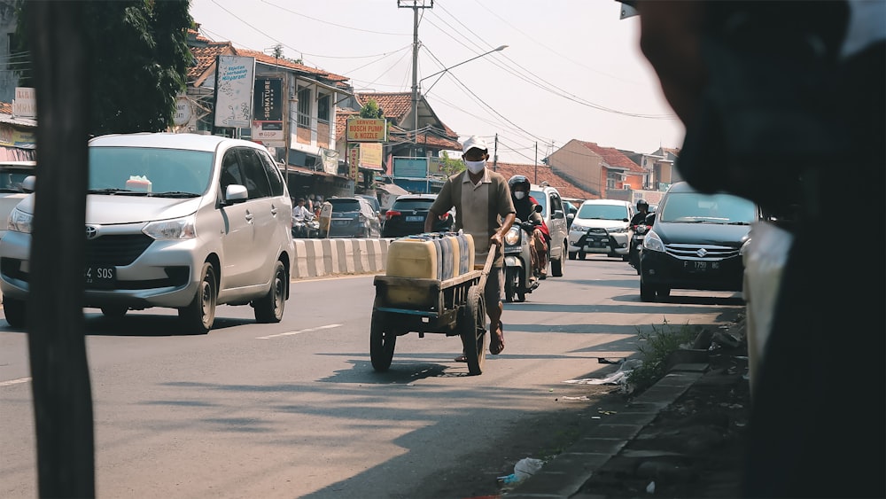 people riding on white and brown wooden cart on street during daytime