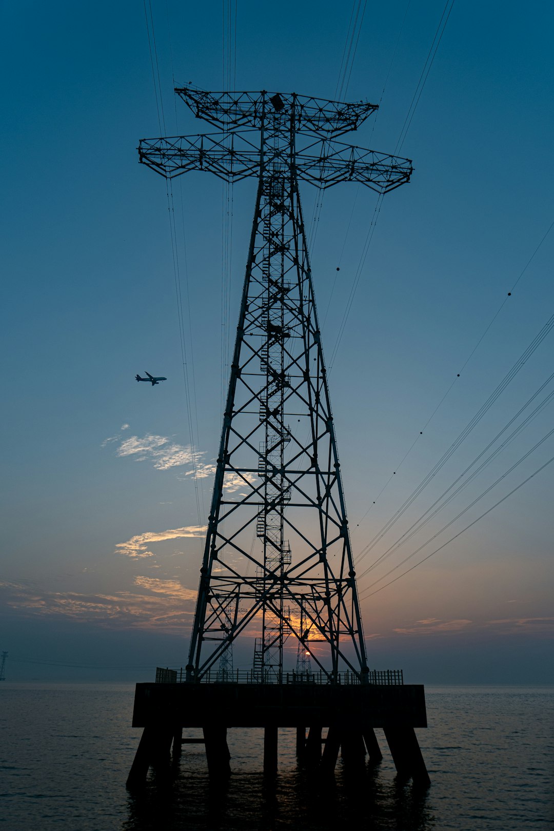 black metal electric tower under blue sky during daytime