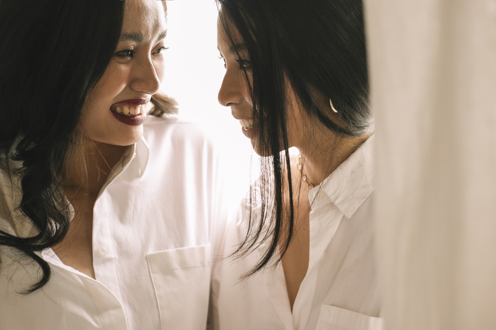 woman in white button up shirt smiling