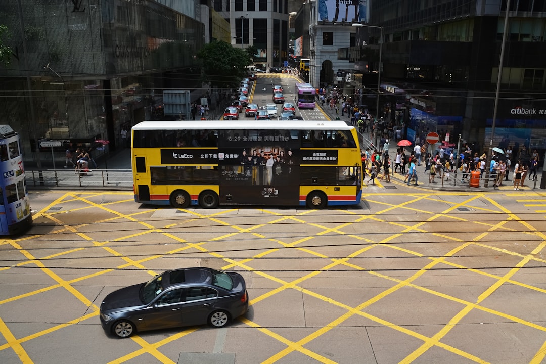 black and red bus on road during daytime