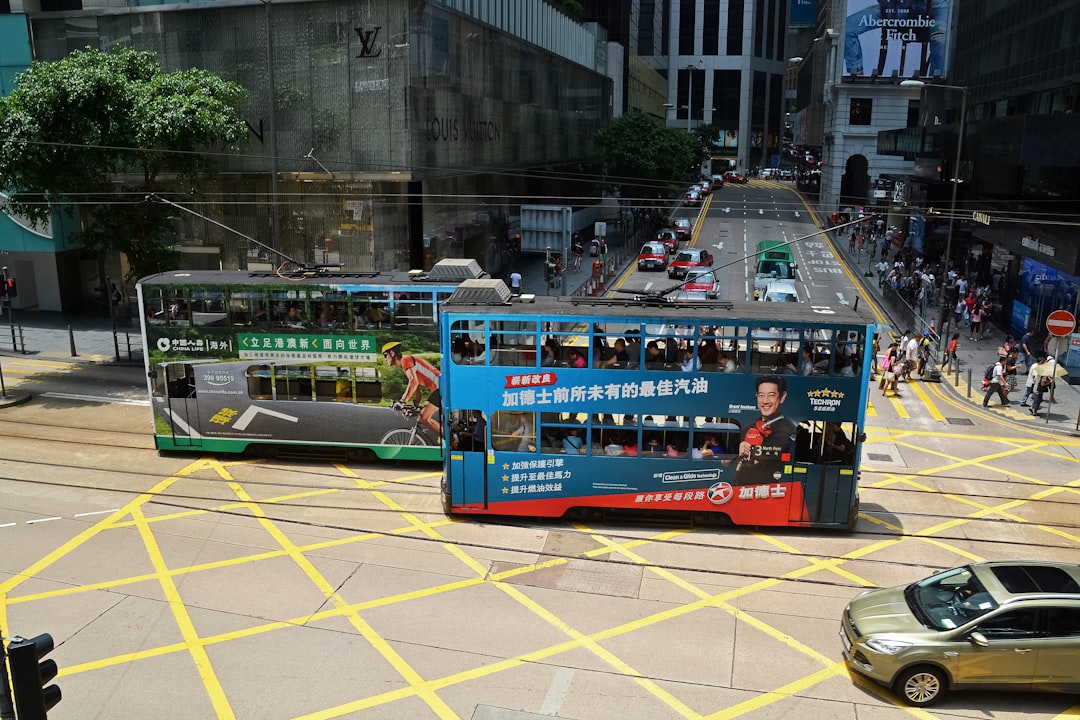 blue and red bus on road during daytime