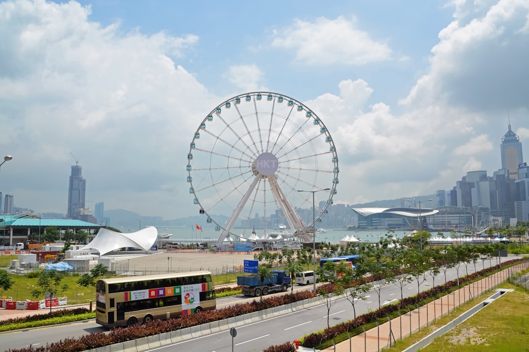 white ferris wheel under white clouds during daytime