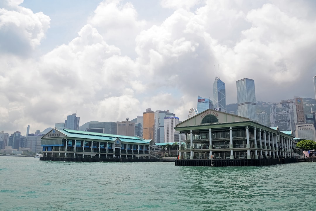 white and green building near body of water during daytime