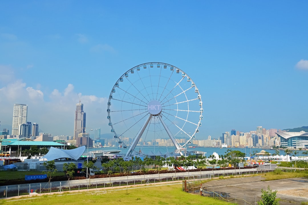 white ferris wheel near city buildings during daytime