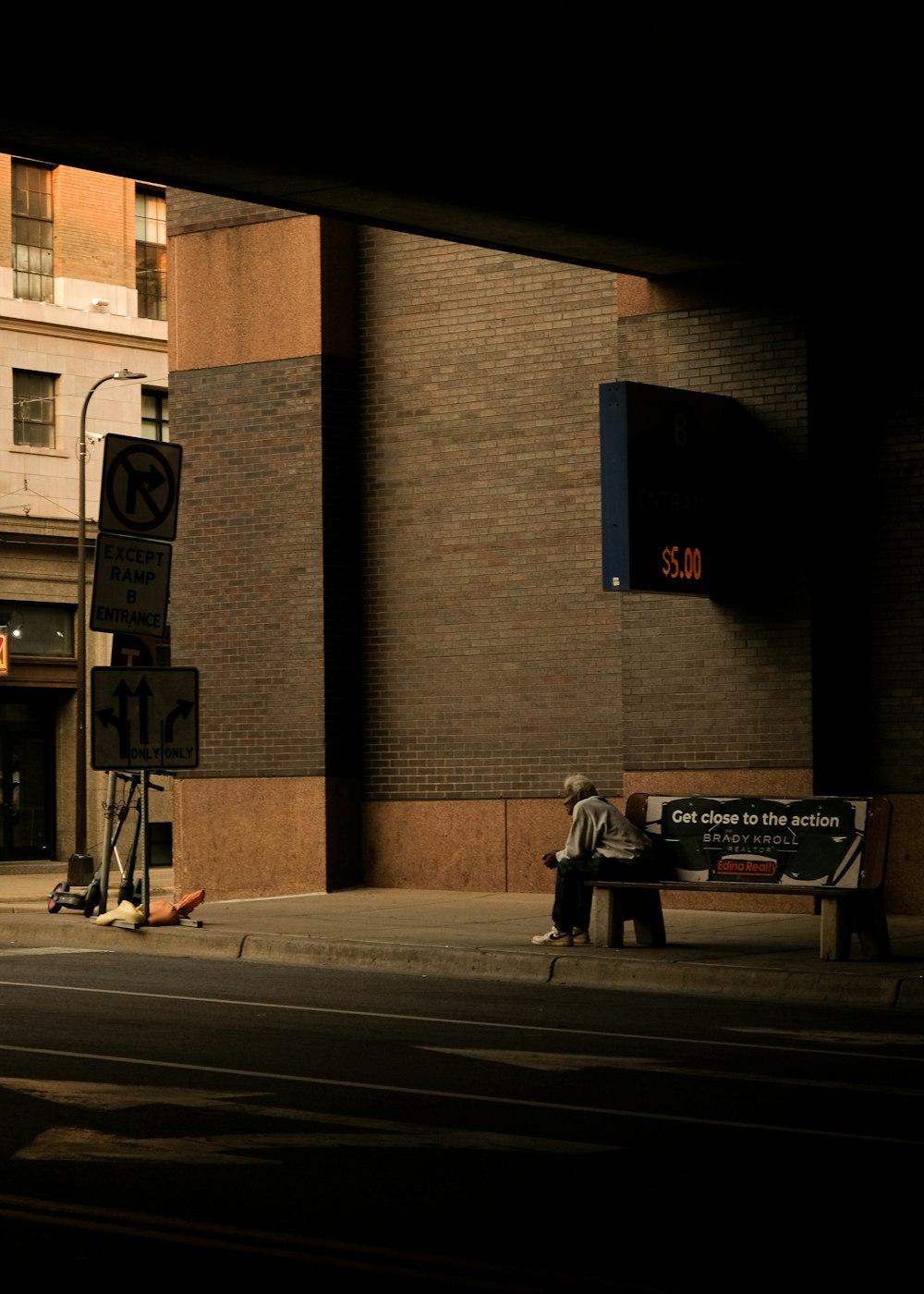 man in black jacket and black pants walking on sidewalk