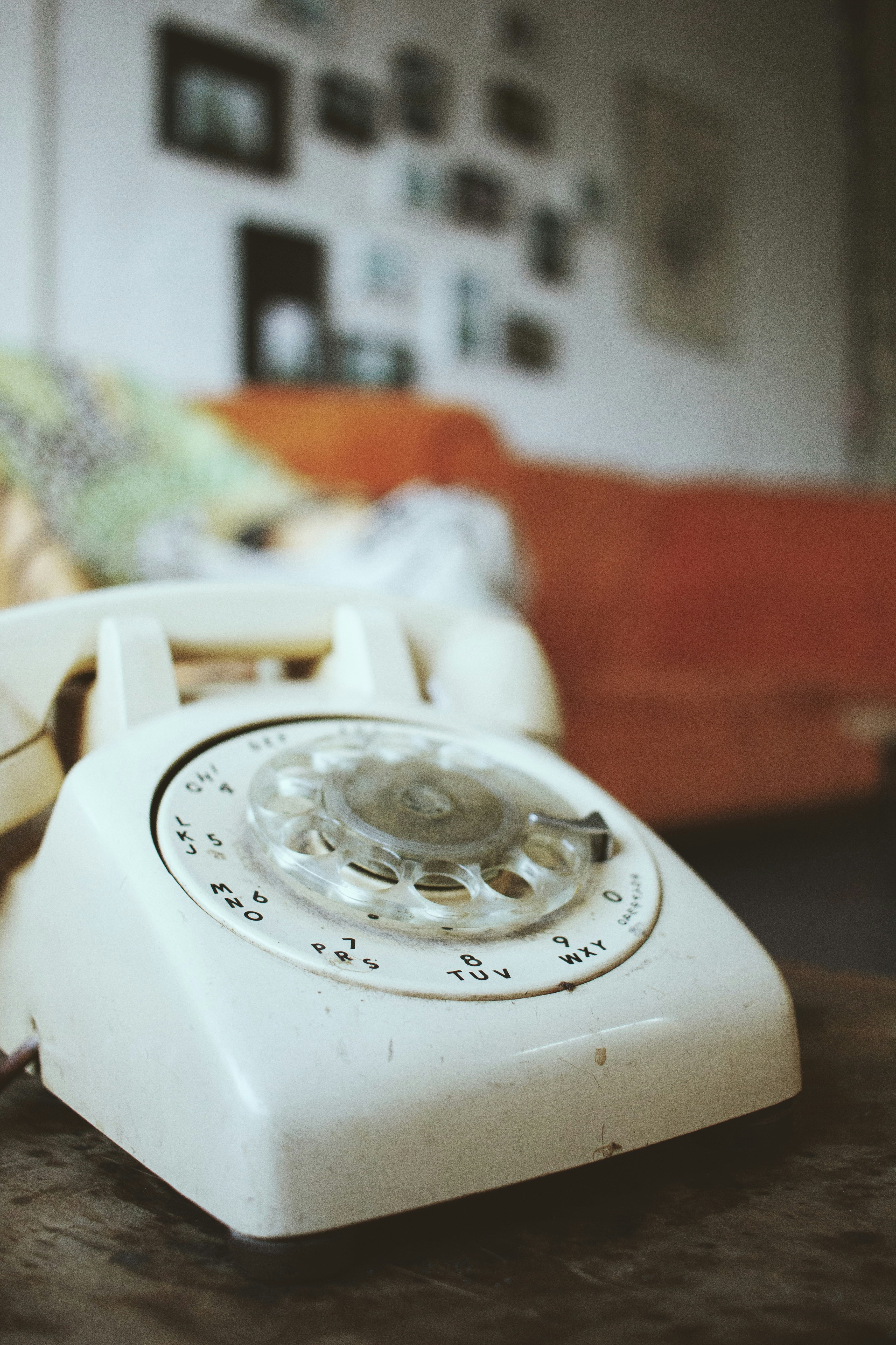 white rotary phone on brown wooden table