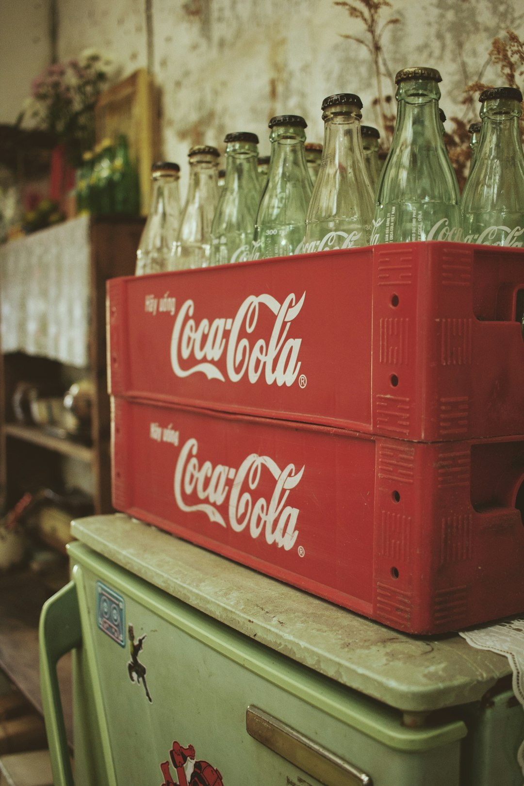 coca cola bottles on white and green wooden table