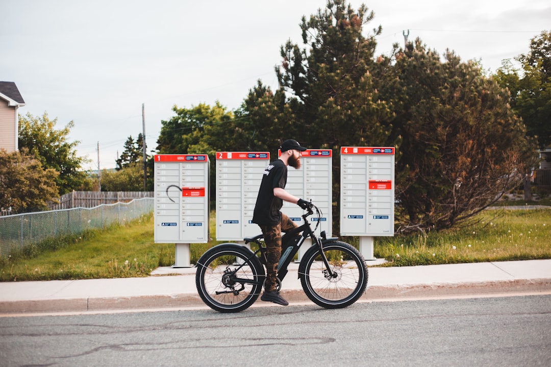 man in black t-shirt riding on black bmx bike during daytime