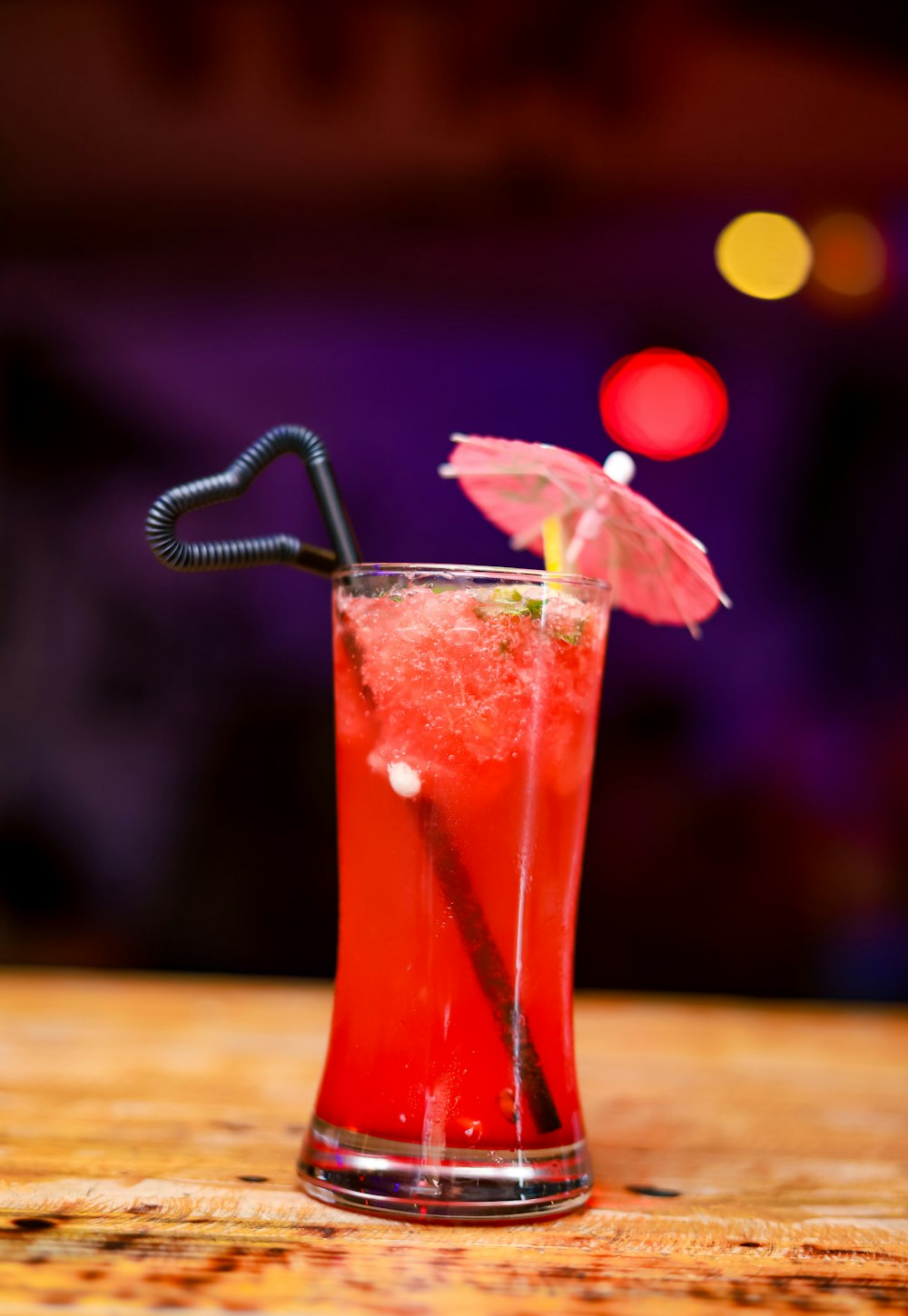 clear drinking glass with red liquid and ice