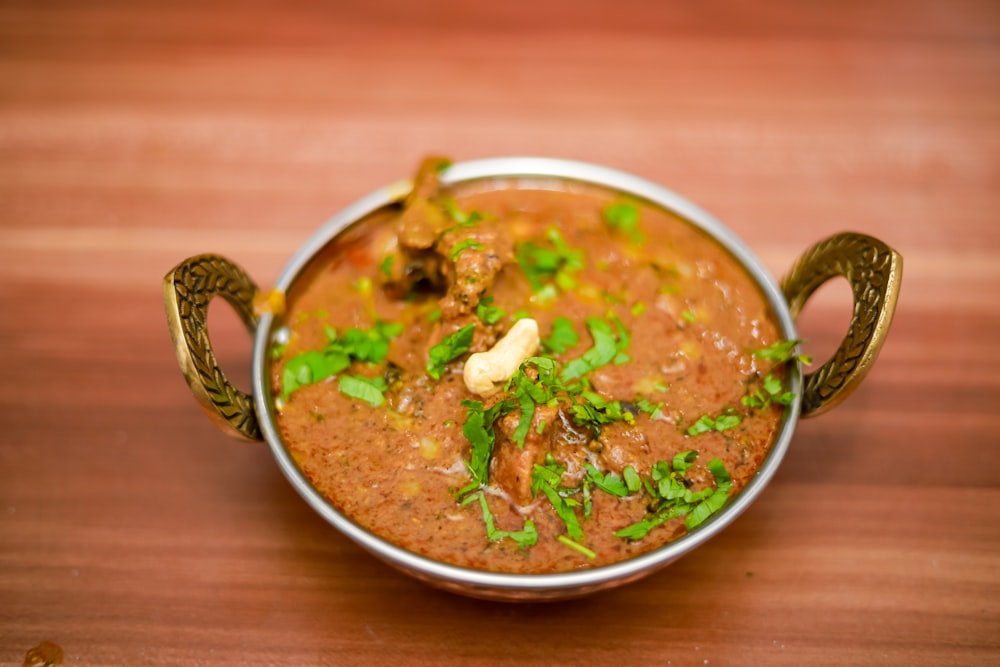 soup with meat in white ceramic bowl