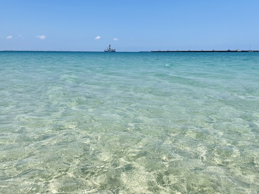 person in water under blue sky during daytime