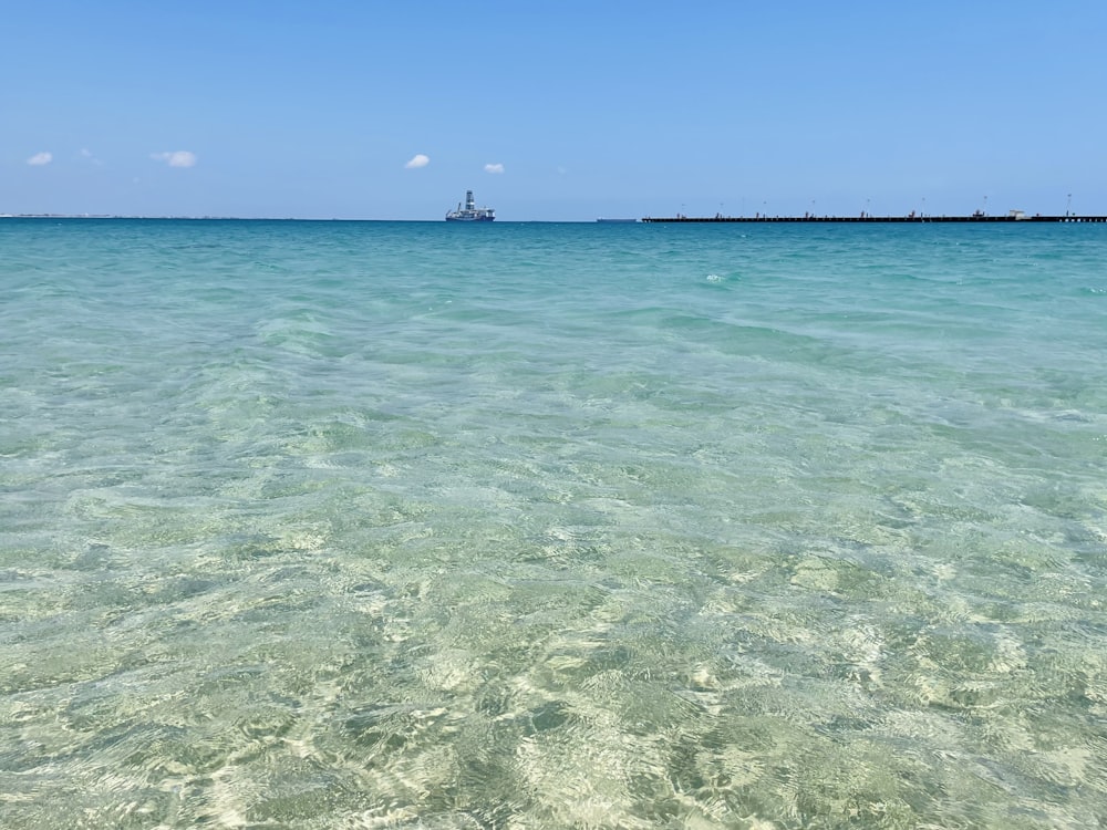 person in water under blue sky during daytime