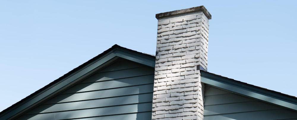 Brick chimney painted white.