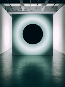 A stylish black and white alarm panel glowing softly in a dim room.