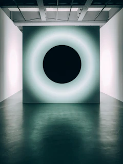 A sleek, frosted glass panel glowing softly with electric saffron neon accents against a deep obsidian-black background.