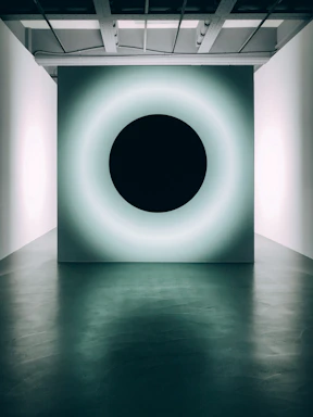 A sleek frosted glass panel glowing softly with electric saffron neon accents against an obsidian-black background.