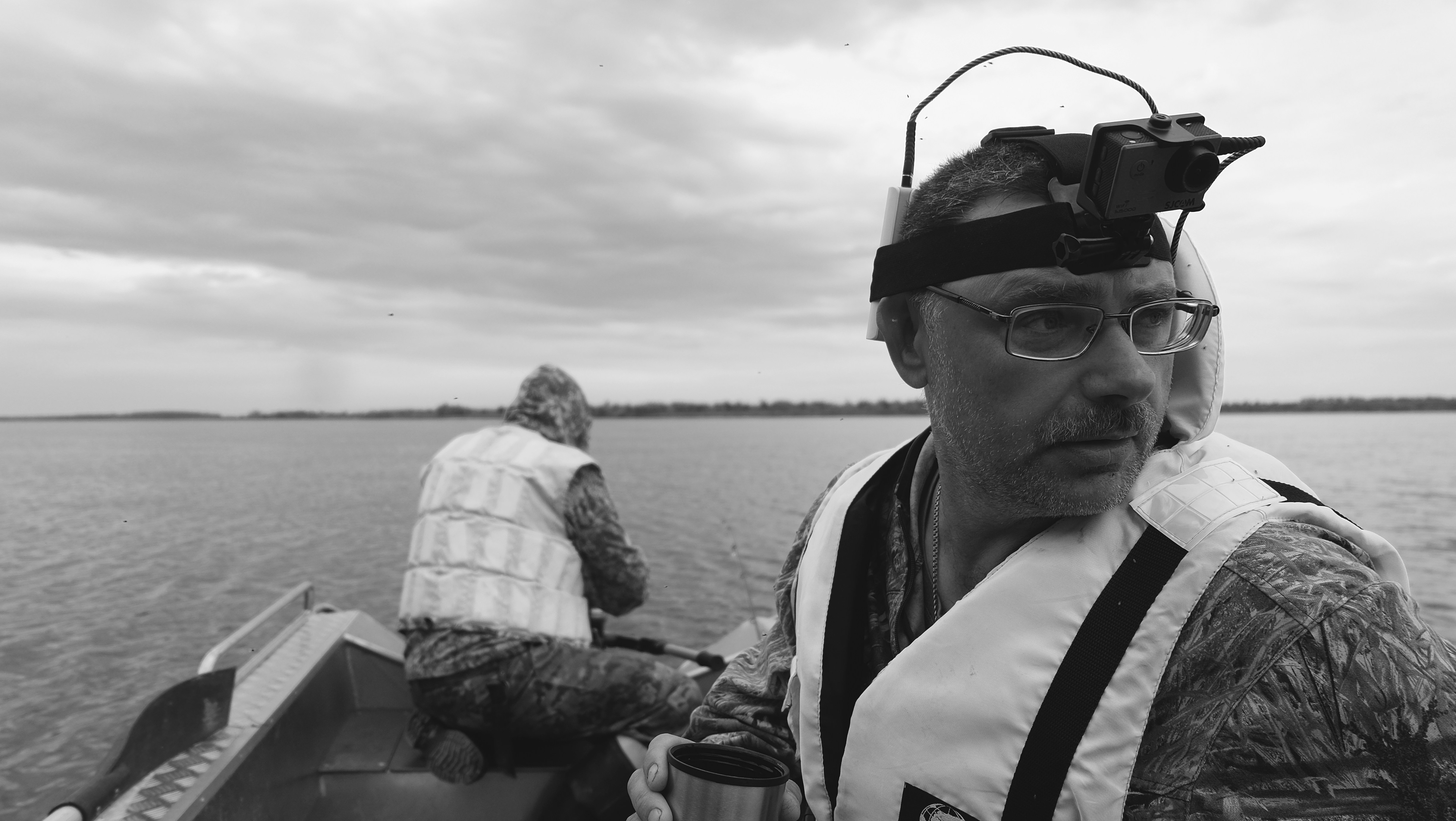 man in black sunglasses and white and black jacket