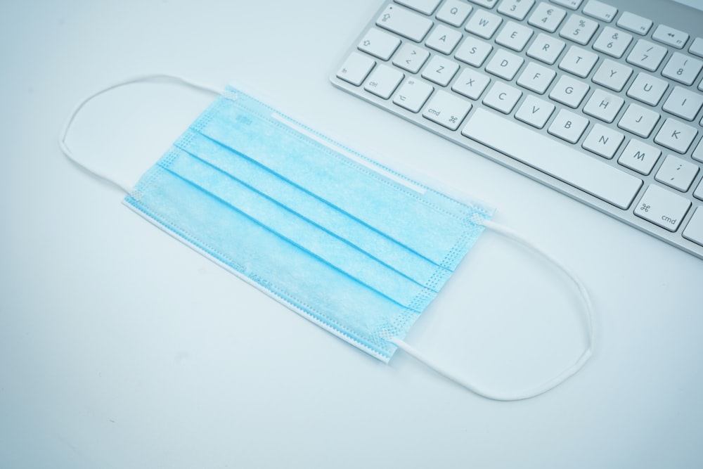 blue and white leather pouch on white table