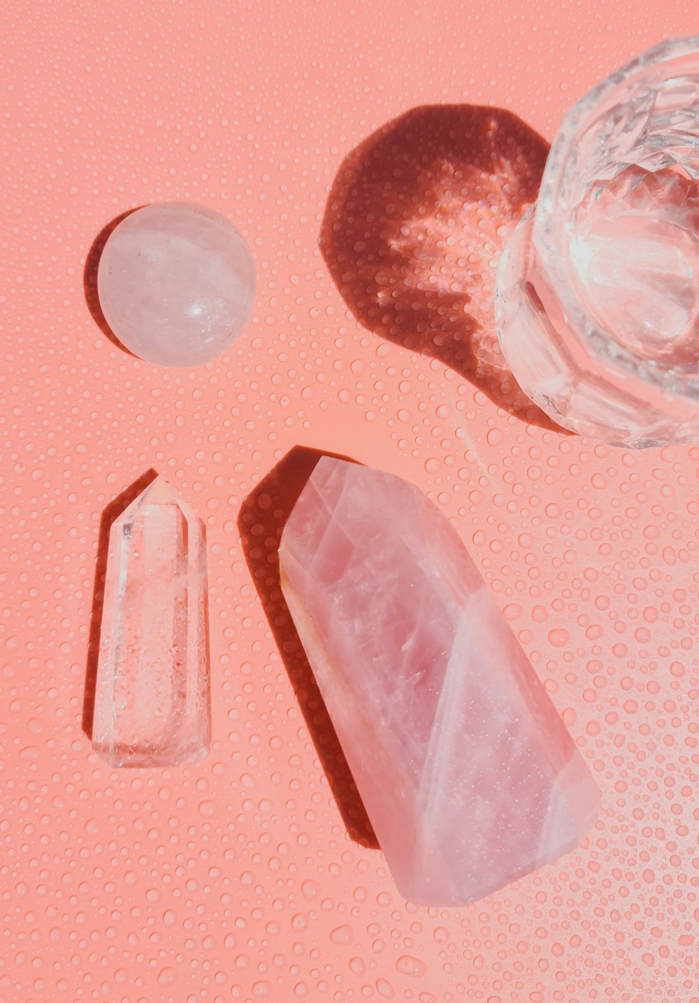 clear drinking glass on pink table